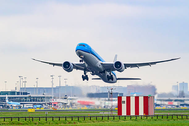 KLM Boeing 787 Dreamliner airplane taking off from Schiphol airport on the Kaagbaan. KLM stands for Koninklijke Luchtvaart Maatschappij, Royal Dutch Airlines and is part of Air France–KLM. The Boeing 787 alos called Dreamliner is a wide-body jet airliner by American manufacturer Boeing Commercial Airplanes. Schiphol is one of the busiest and largest airports in Europe, located near Amsterdam, Netherlands. It serves as a major hub for international flights and is a key gateway to Europe.