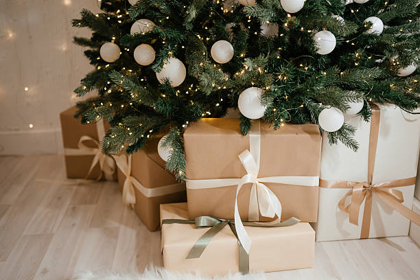 Christmas Gifts under a Decorated Tree with Lights