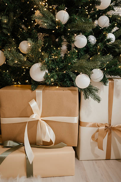 istock Christmas Gifts under a Decorated Tree with Lights 2246306064