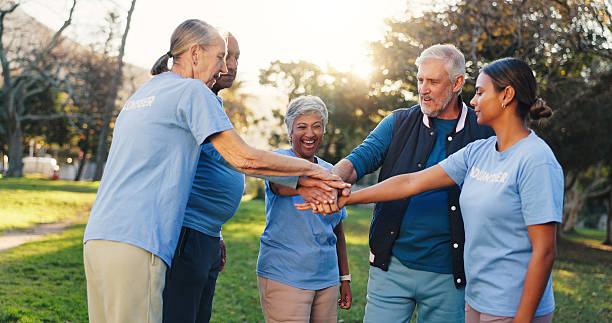 istock People, volunteer and stack hands at park, motivation and celebration with social responsibility. Women, men and excited with senior team, support or goals with success at charity event in summer 2246307527