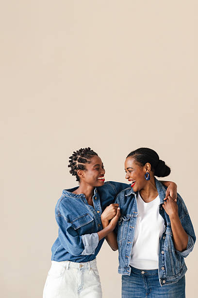 istock Mother And Daughter Portrait In Denim Jackets Sharing Laughter In Studio 2246309128