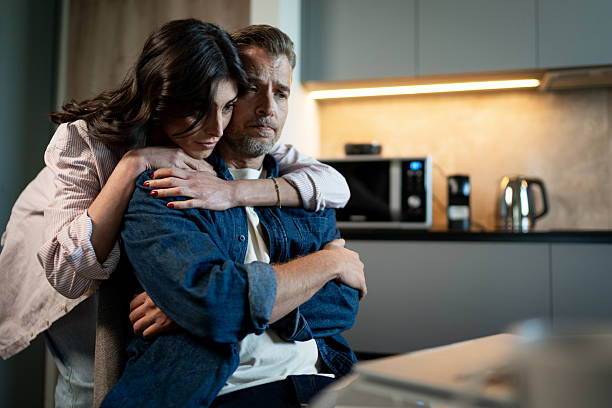 istock Woman comforting sad man at home 2246310174
