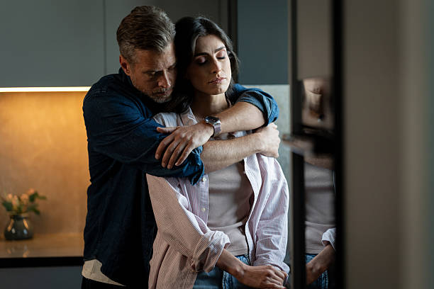 istock Man comforting sad woman during difficult times at home 2246310189
