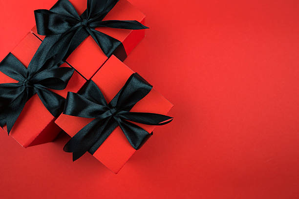 istock Top view photo of gift boxes with bow on isolated red background. 2246310499