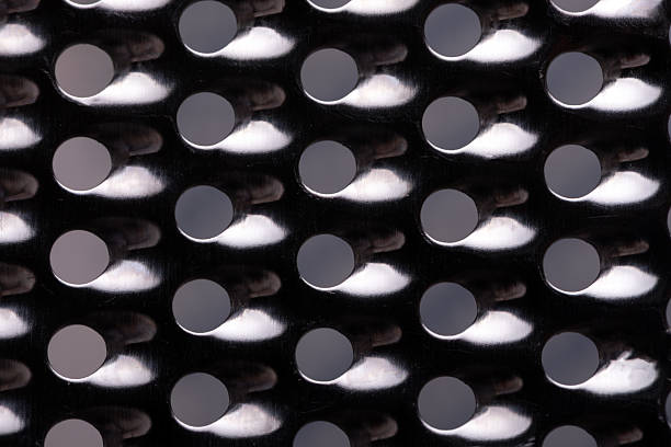 istock Close-up of metallic surface with repeating circular 2246311985