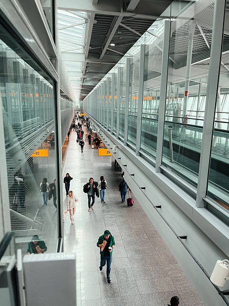 Warsaw, Poland, October 10, 2025 – Aerial view of passengers waiting in Chopin Airport corridor, symbolizing patience, journey, and organized movement.