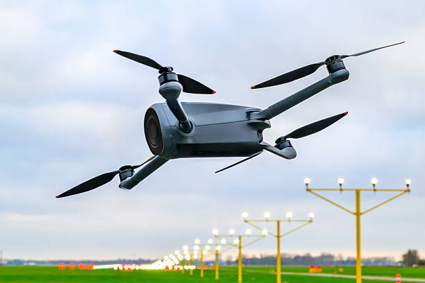 Drone flying close to Schiphol airport in The Netherlands. Incidents involving drones (unmanned aerial vehicles, UAVs) at or near airports have become a growing safety and security concern worldwide. These events typically involve drones being flown—intentionally or accidentally—into restricted airspace, disrupting commercial aviation and posing risks to aircraft and passengers.  Disclaimer: no drone rules were violated for this photo. The drone is hanging on a tripod with nylon wires and turned off.