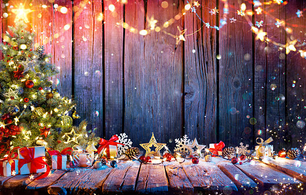 istock Christmas Tree With Gift Boxes On Rustic Wooden Table With Garland And Decorations - Abstract Bokeh Lights 2246317805