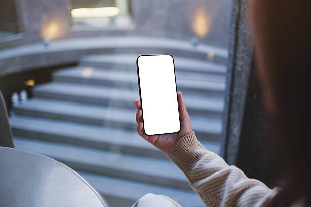 istock Mockup image of a woman holding and using mobile phone with blank desktop screen in cafe 2246318562