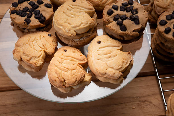 istock Buttery cookie sandwich with chocolate chips dessert on plate, cute animal shape biscuit snack, golden baked treat for cafe display and home bakery joy 2246319314