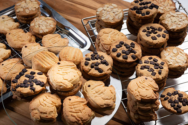 Cookie chips chocolate dessert on rustic wood scene shows homemade butter cookie with chocolate chips and almond topping, golden baked texture, cozy mood, fresh from oven on cooling rack and plate