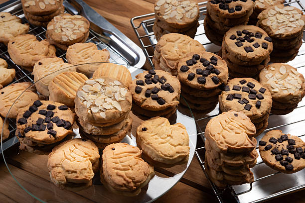 istock Fresh cookie with chocolate chips on cooling rack, golden biscuit stacked on wire tray, crunchy dessert aroma fills home bakery scene with warm light and cozy mood 2246319352