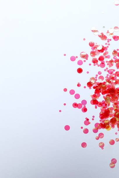 istock vertical view of pink confetti on a light background 2246319384