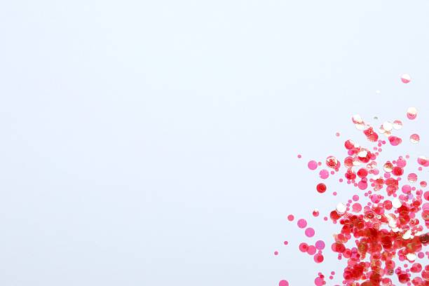 istock shiny pink confetti on a color background 2246319396