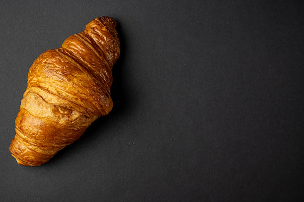 istock Fresh Croissant and black background 2246319929