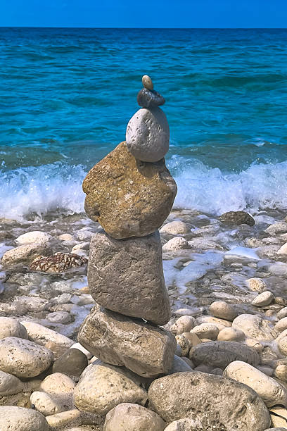 istock Made of stone tower on the beach. Balanced pebbles on beach 2246320934