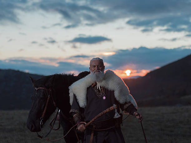istock A Viking warrior on a large black horse surveys a dramatic landscape during sunset, wearing a fur cloak. The scene evokes ancient exploration, adventure, and the spirit of the wild. 2246322502