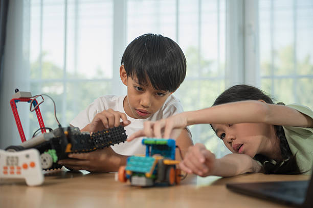 istock Kids playing with construction blocks on table, child playing and building with colorful plastic bricks. 2246322630