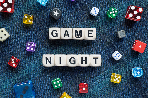 Game Night spelt using wooden word dice over a dark fabric.