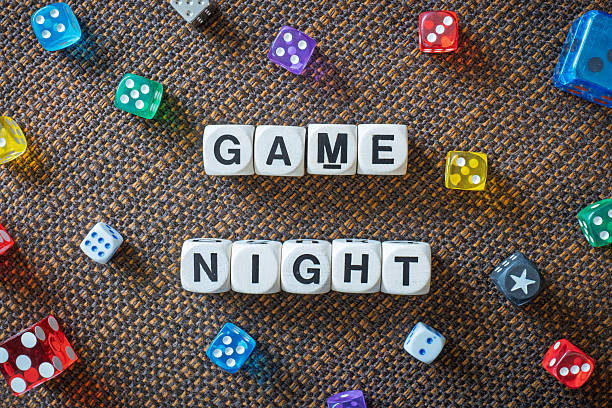 istock GAME NIGHT spelt using wooden word dice over a brown table cloth. 2246323827