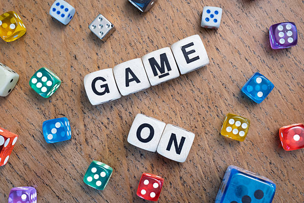 istock GAME ON spelt using wooden word dice over a pale wooden tabletop. 2246323829