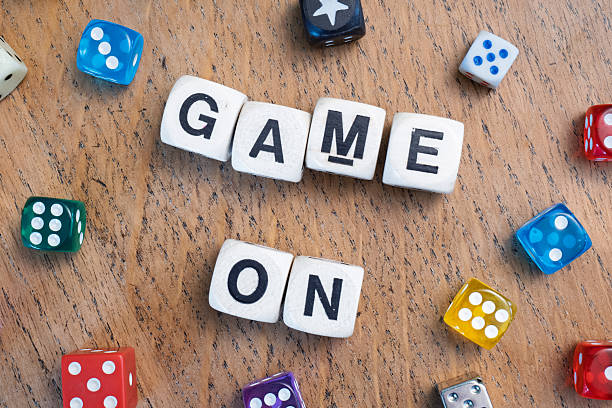 istock GAME ON spelt using wooden word dice over a pale wooden tabletop. 2246323838