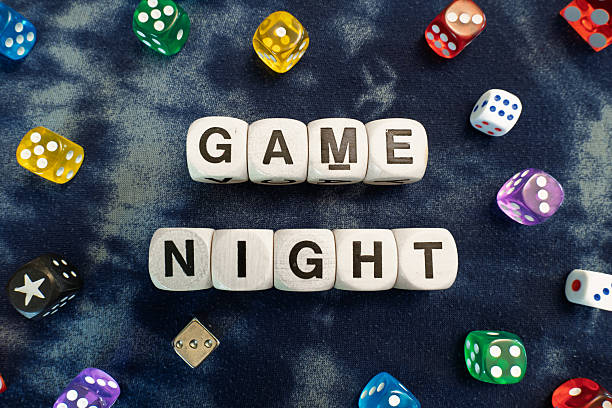 istock GAME NIGHT spelt using wooden word dice et over a swirly blurred fabric. 2246323842