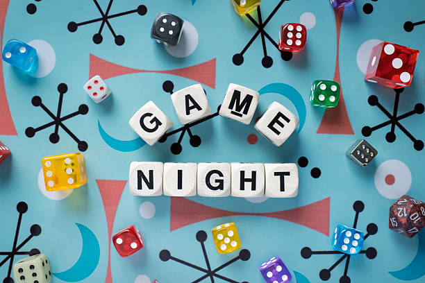 istock GAME NIGHT spelt using wooden word dice set over a playful retro background. 2246323844