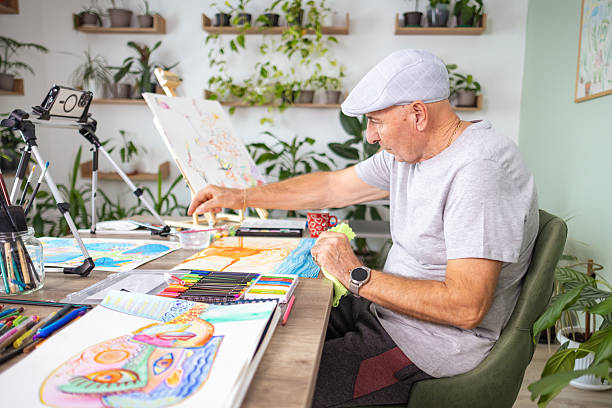 istock Senior Illustrator Drawing in Plant-Filled Studio 2246324058