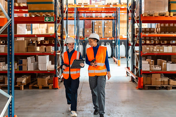 istock Women logistics workers discussing inventory in warehouse 2246324158