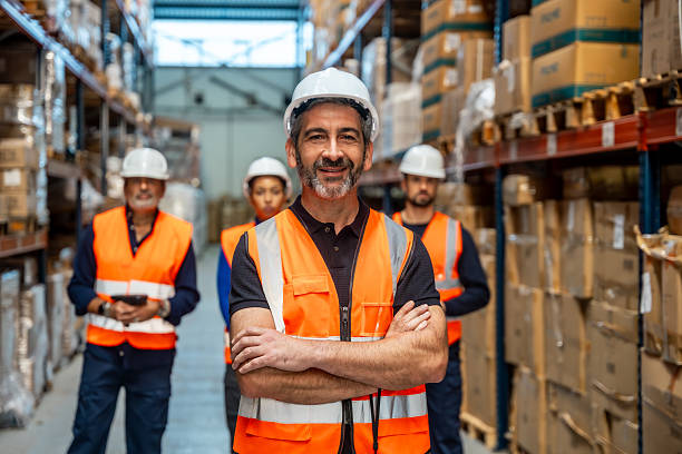 istock Warehouse supervisor smiling with logistics team members 2246324160