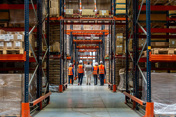 istock Group of warehouse workers supervising inventory in distribution center 2246324295