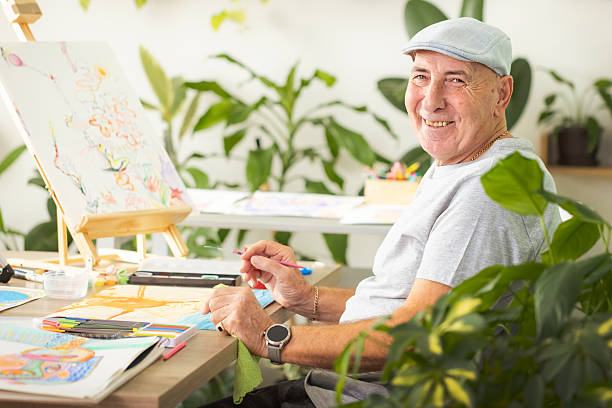 istock Senior Illustrator Drawing in Plant-Filled Studio 2246325643