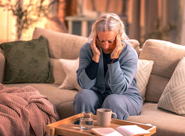 istock Senior woman suffering from migrane at home 2246326718