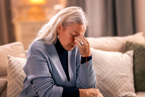 istock Senior woman suffering from migrane at home 2246326741