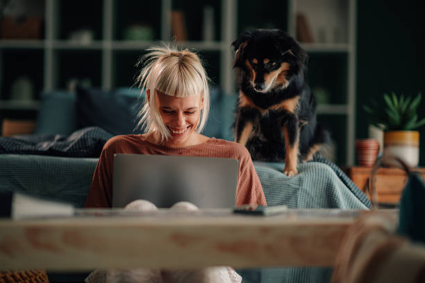 istock Woman working from home sitting with pet dog 2246327847