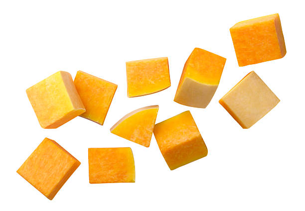 istock Pumpkin pieces flying close-up on a white. Isolated 2246328609