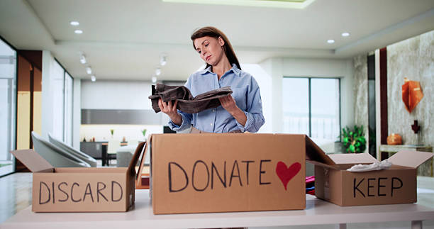 Woman Decluttering Closet, Organizing Wardrobe, Trying On Clothes Selection stock photo