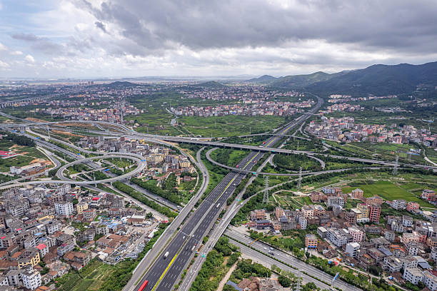 istock Complex highway overpasses on plain farmland and houses 2246331404
