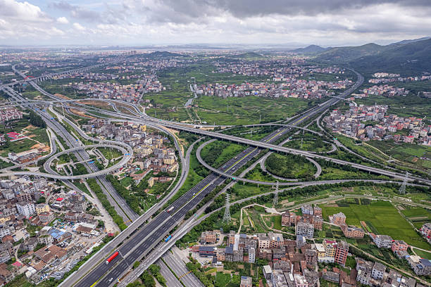 istock Complex highway overpasses on plain farmland and houses 2246331431