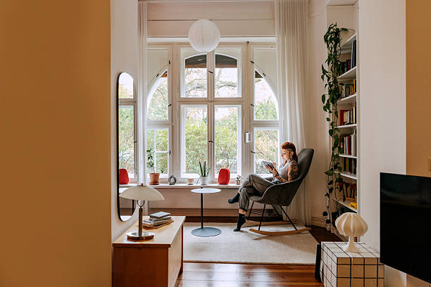 istock Young woman working from home on tablet by window 2246331575