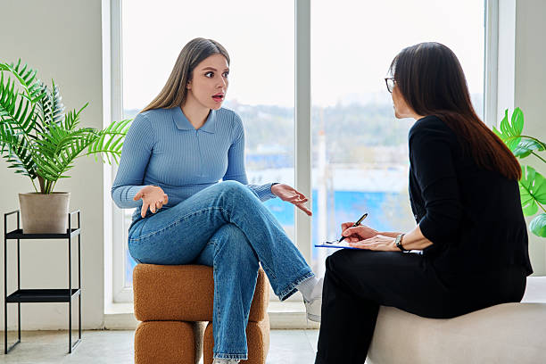 istock Young woman in a therapy session talking with a psychotherapist 2246332480