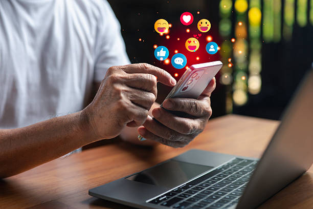 istock Man using smartphone with social media icons floating above the screen, showing online communication, connection, and digital marketing concepts in a modern technology lifestyle. 2246333721