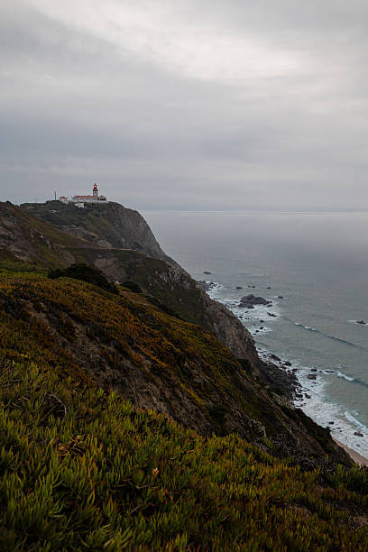 istock Cabo da Roca lighthouse overlooking steep cliffs and Atlantic Ocean under a cloudy sky on Portugal's dramatic western coast 2246333862