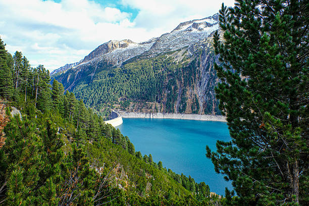 Austria - green mountain lake with dam near Grossglokner. Mosserboden dam and alpine peaks in the background .Panorama view of Stausee Wasserfallboden, Hohe Tauern Alps - Kaprun