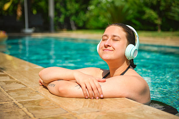 istock young woman relaxes and has fun in the pool 2246335142