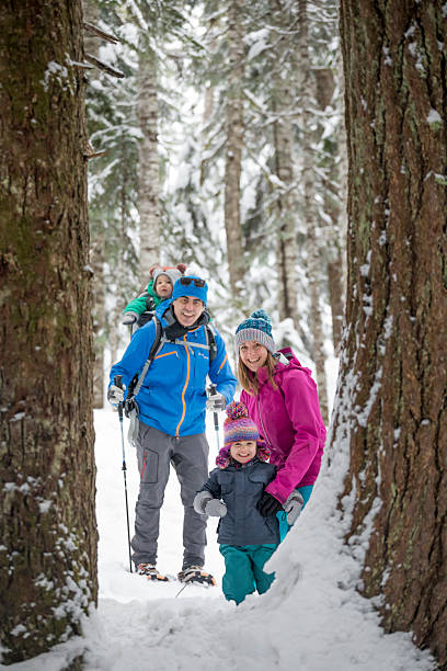 istock Family snowshoes through forest 2246335747