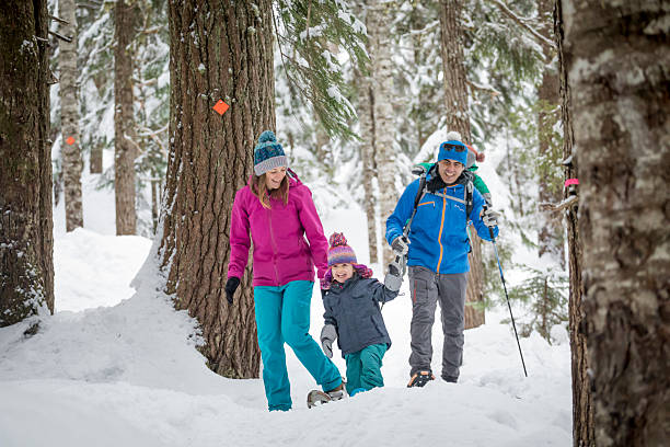 istock Family snowshoes through forest 2246335767