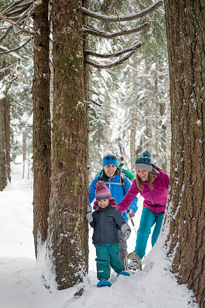 istock Family snowshoes through forest 2246335773