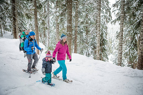 istock Family snowshoes through forest 2246335779